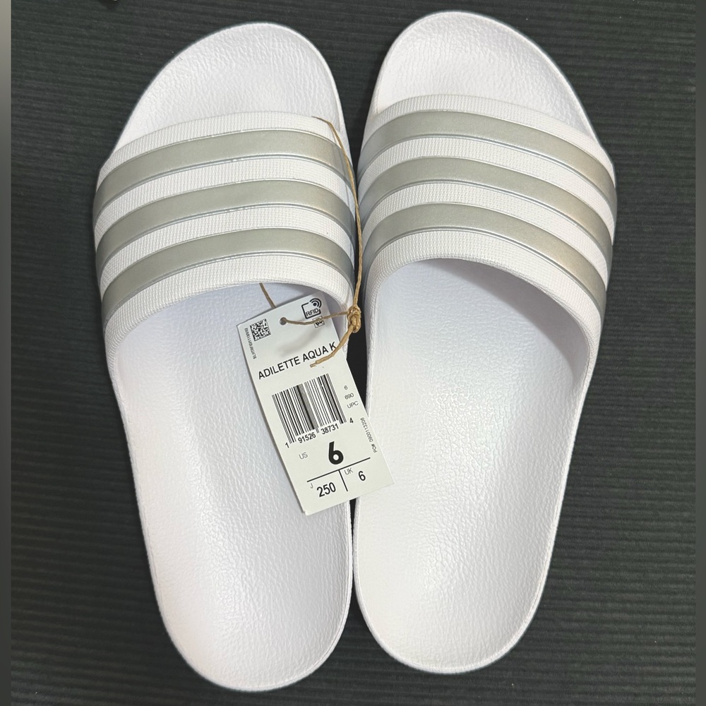 Adidas Kids’ Adilette Aqua Slides
White Cloud/Silver Metallic